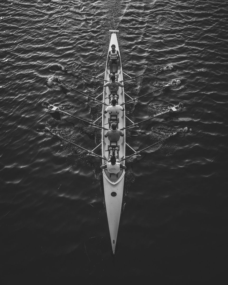 A rowing crew pulling together in unison, seen from above