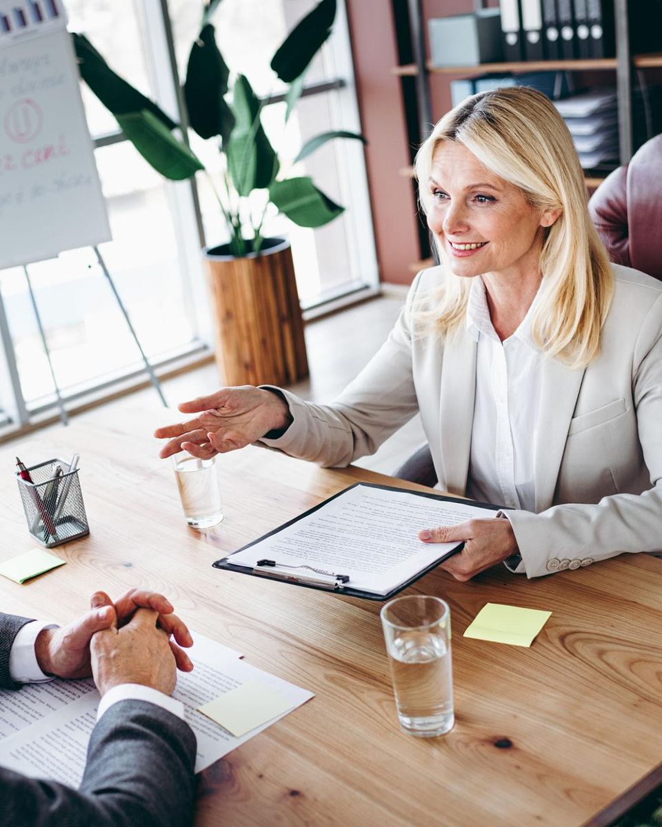 An HR advisor explaining a plan across the desk to a business owner